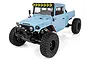 Element RC Enduro Zuul 1/10 scale RC rock crawler truck in light blue with black off-road tires and a roof-mounted light bar.