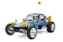 Tamiya Wild One Blockhead Motors 1/10 scale RC buggy in blue with yellow accents, off-road tires, and a driver figure.