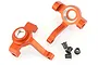 Two orange anodized aluminium RC steering hubs with four small black bushings on a white background.