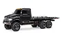 A studio shot of the black Traxxas TRX-6 Ultimate 6X6 Hauler RC truck from a side-angle view against a white background.