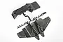 Two black plastic RC car chassis parts attached to a sprue tree on a white background.