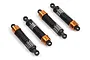 A set of four HPI Racing adjustable RC shock absorbers with orange anodized aluminum collars and black springs on a white background.