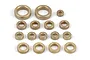 A collection of various sized brass bushings arranged on a white background.