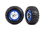 Two Traxxas 2.2/3.0 inch BFGoodrich Mud Terrain T/A KM2 tyres mounted on chrome and blue beadlock-style rims, shown from front and angled perspectives.