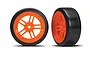Two orange split-spoke RC car wheels with smooth black drift tyres, shown from front and angled views against a white background.