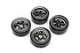 A set of four Traxxas RC drift wheels featuring chrome split-spoke rims and smooth, hard black plastic tyres arranged on a white background.