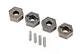 Four Traxxas Extreme Heavy Duty 12mm wheel hexes and four matching metal drive pins arranged on a white background.