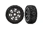 Two Traxxas Sledgehammer RC monster truck tires mounted on grey multi-spoke wheels, shown from front and side angles against a white background.