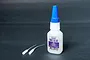 A 20g bottle of Koswork Premium Tire Glue with a blue cap and two additional applicator tips on a dark grey background.