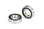 Two Traxxas rubber-shielded ball bearings shown on a white background, one lying flat and one standing upright.