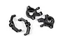 A set of four black plastic RC steering hubs and C-hub carriers from Traxxas, shown on a white background.