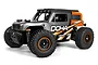 Maverick Doha 1/20 scale RC desert truck in orange and grey with black off-road tires and a roll cage design.