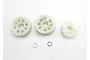 Traxxas output gear set including three white plastic gears, a small white spacer, and a metal washer on a white background.