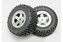 Two Traxxas 1/16 scale off-road RC wheels with black rubber tyres and satin chrome rims, shown against a plain white background.