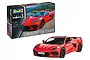 A Revell 1/25 scale Corvette C8 Coupe plastic model kit box next to a fully assembled and painted red model car.