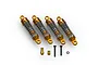 A set of four gold-anodized aluminium RC shock absorbers with silver springs, accompanied by mounting hardware on a white background.