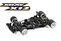 A studio shot of an XRAY X12 1/12 scale RC pan car chassis, fully assembled with electronics, on a white background.