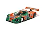 A studio shot of a Tamiya Mazda 787B RC car featuring the iconic green and orange Renown livery with number 55 decals.