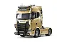 A 1/14 scale Tamiya Scania 770 S RC semi-truck model painted in a metallic gold finish with a black bull bar and custom decals.