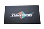 A rectangular Team Powers pit mat featuring a black carbon fiber pattern and the Team Powers logo in the center with orange and blue accents.