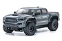 Kyosho 1/10 scale RC Toyota Tacoma TRD Pro in Lunar Rock grey, shown from a front three-quarter angle on a white background.