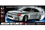 Product box art for Tamiya TT-02D Nissan Skyline GT-R R32 RC drift car, featuring a silver model car drifting on a dark background.