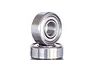 A close-up studio shot of two small metal shielded ball bearings stacked on top of each other against a plain white background.