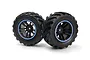 Two BlackZon Spryte RC monster truck wheels with black rubber tyres and black rims featuring blue accent rings, set against a white background.