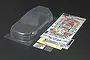 A clear, unpainted Tamiya 1/10 scale Honda Civic VTi RC body shell with included decal sheets and masking tape on a dark background.