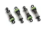 Four Maverick RC shock absorbers with green anodized aluminum caps and collars, black plastic ends, and silver coil springs on a white background.