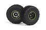 Two black RC off-road tires mounted on black 12-spoke rims with bright green beadlock-style rings, isolated on a white background.