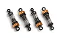 Four Maverick RC shock absorbers with orange anodized caps and black plastic ends arranged on a white background.