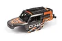 A pre-painted orange and grey Maverick Doha RC truck body shell with black roof accessories, viewed from a high angle against a white background.