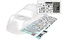 Clear, unpainted Traxxas Slash Late Model RC body shell with included decal sheets and a separate inset showing black plastic accessories and a rear wing.