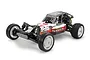 A studio shot of the Tamiya DT-04 Fighter NXGEN RC buggy, a white and black 2WD electric off-road kit with a driver figure.