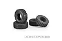Two black rubber RC crawler tyres and two black foam inserts arranged on a white background.