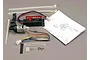 Traxxas EZ-Start system kit including the starter motor unit, control box, wiring, zip ties, screws, and an instruction manual on a grey surface.