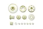 A collection of various off-white plastic RC car gears and small components arranged on a white background.