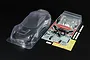 Tamiya 1/10 scale clear polycarbonate Porsche 911 GT3 R 992 RC car body shell with included decal sheet, rear wing, and plastic parts.