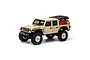 Axial SCX24 Jeep Gladiator RC rock crawler in beige, featuring a black roof, off-road tires, and a red fuel canister in the truck bed.