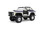 Axial SCX10 III Early Ford Bronco RC rock crawler in white with blue side stripes, black roll cage, and off-road tires on a white background.