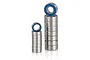 Two stacks of metal ball bearings with blue rubber seals, arranged on a white reflective surface.