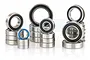 A collection of various sized metal ball bearings with black and blue rubber seals arranged in stacks against a white background.