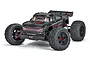Studio shot of the ARRMA Outcast 8S EXB 1/5 scale RC stunt truck in black, featuring aggressive off-road tires and a detailed body shell.