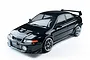 A black 1/10 scale MST RMX 2.5 Mitsubishi Evolution V RC drift car viewed from a high angle against a white background.