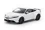 A studio shot of a white Tamiya 1/24 scale Honda Prelude plastic model car with black wheels against a white background.