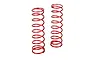 Two red metal coil springs for RC car shock absorbers standing upright against a white background.