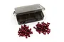 A set of red anodized aluminium RC screws arranged in two piles next to an open, empty, translucent grey plastic storage case.