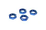 Four blue anodized aluminium serrated wheel nuts for RC vehicles arranged on a white background.