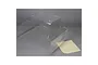 An unpainted clear polycarbonate cab body shell for the Losi 5IVE-T RC truck, shown with a small adhesive sheet on a grey background.